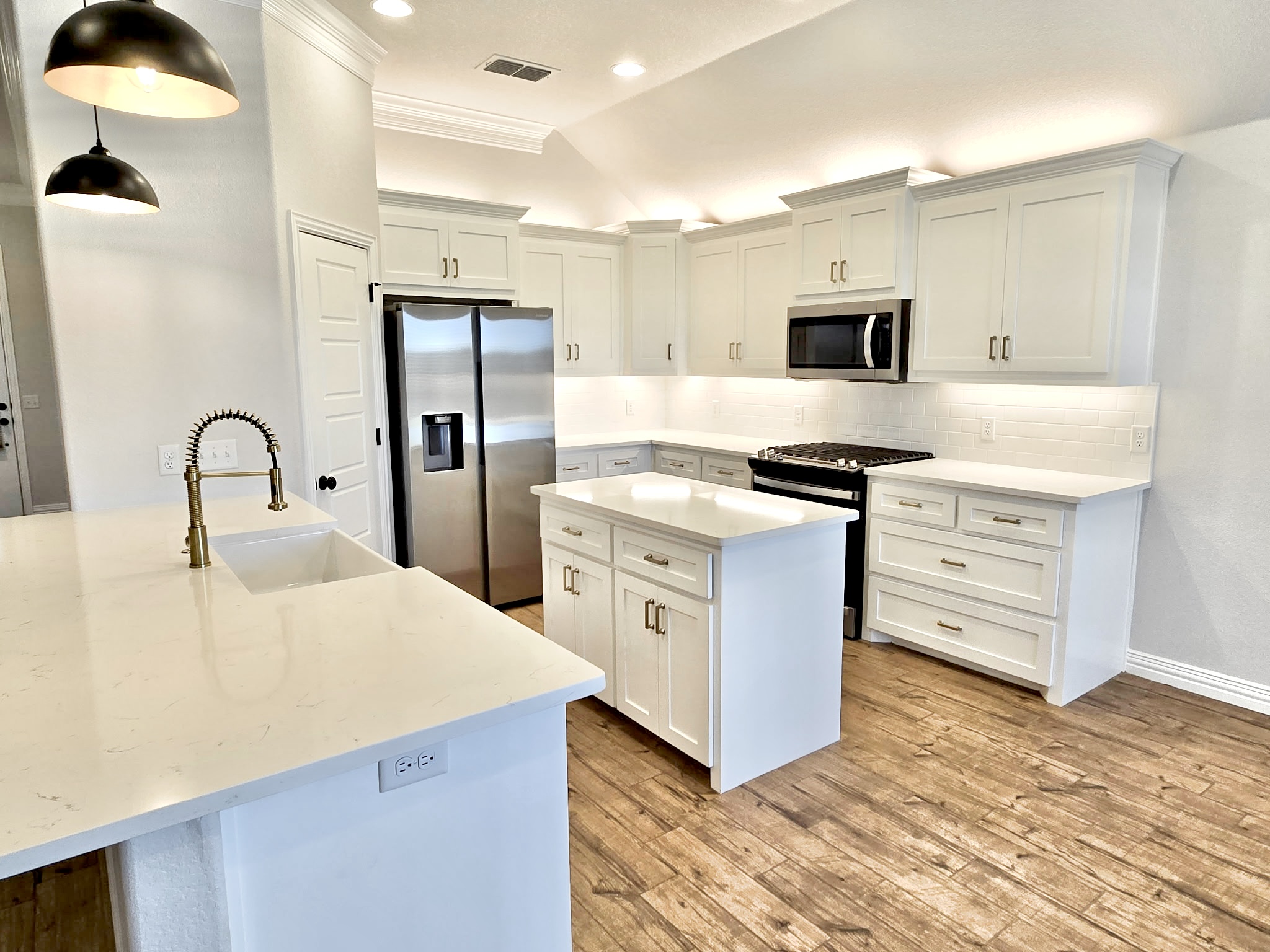 Beautiful white kitchen cabinet refinishing by Top Coat Painting Co.