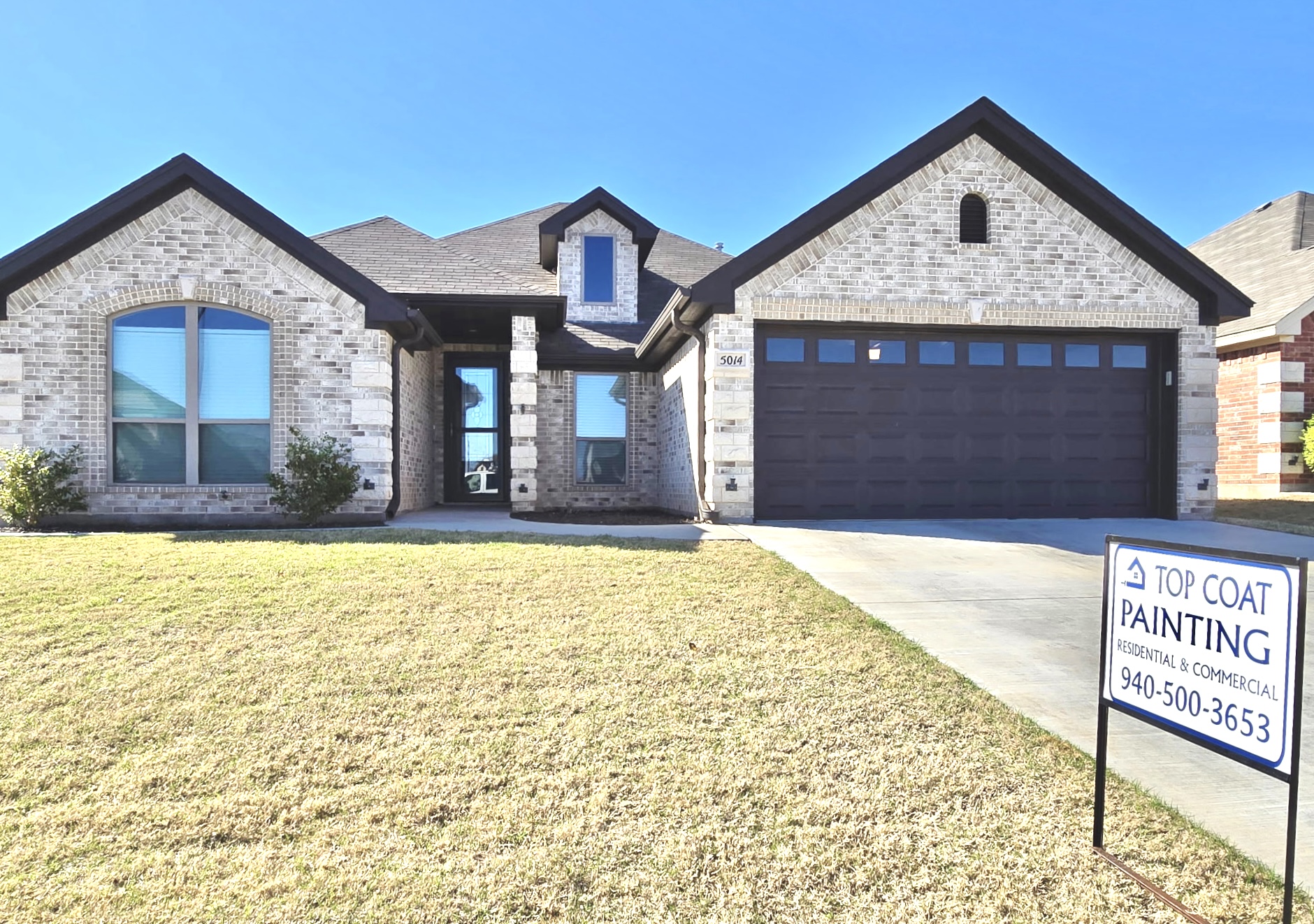 Exterior brick home painted by Top Coat Painting Co.