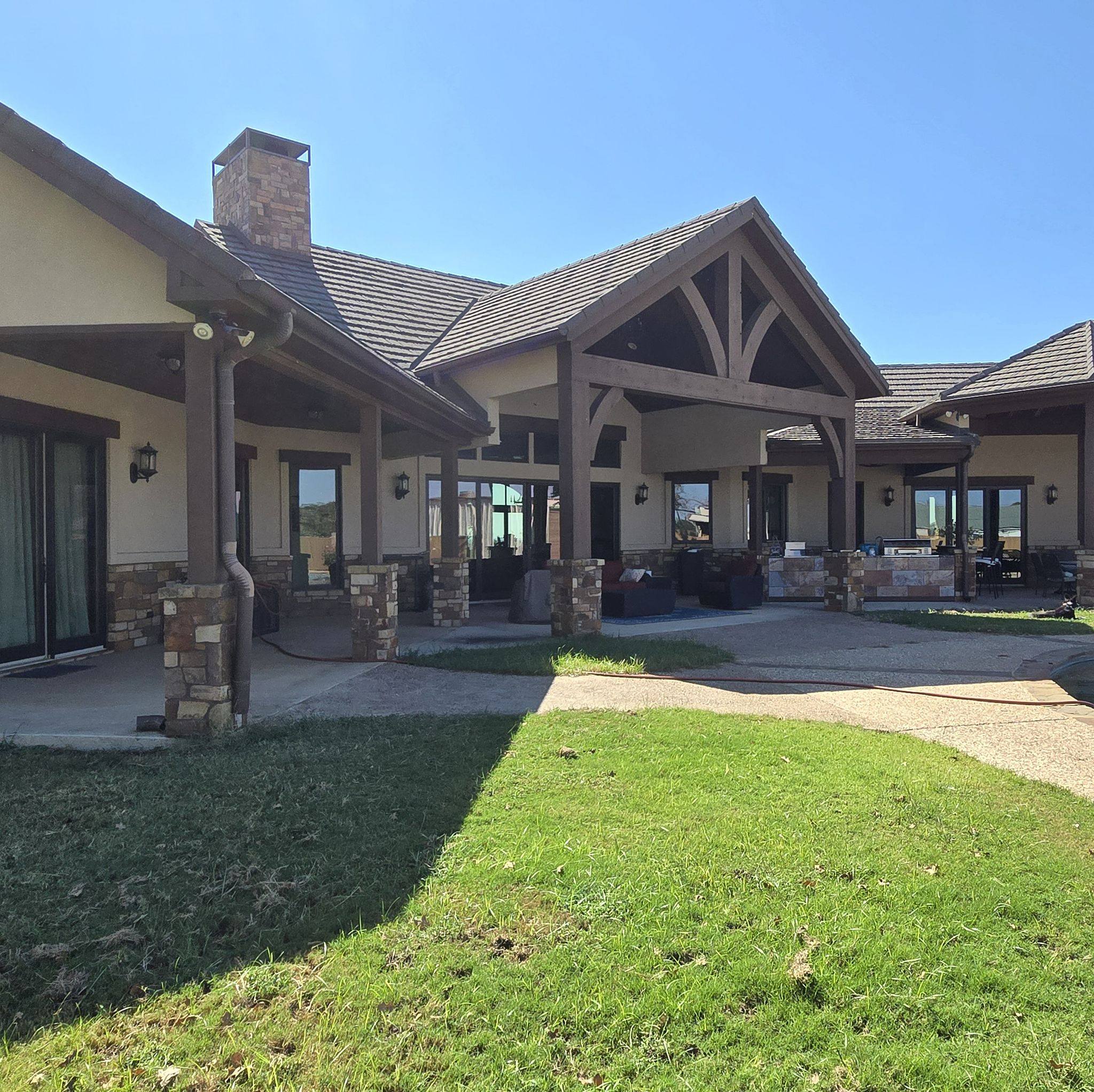 Large residential exterior painting project by Top Coat Painting